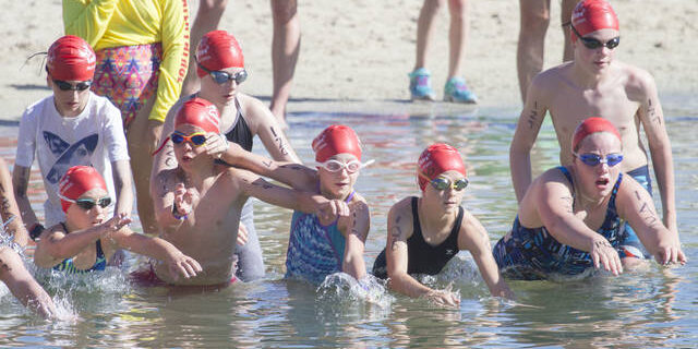 kids enter the lagoon at the Hilton Waikoloa Village to start the Lavakids Aquathlon